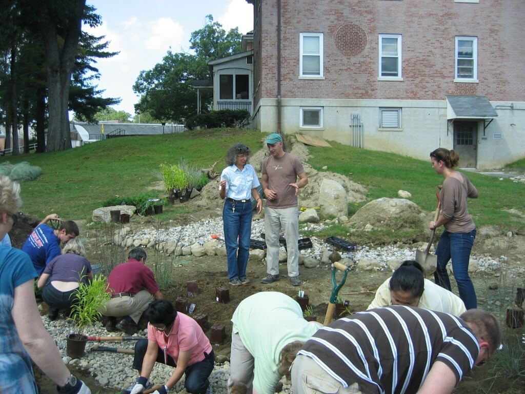 Tom Benjamin, Landscape Architect, with people planting new plants