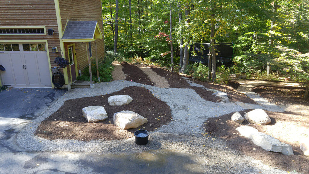 Rock and gravel garden layout on side of house